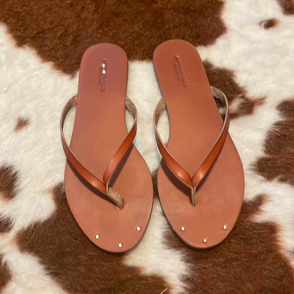 American Eagle brown flip flops.